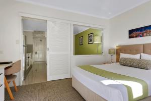 a bedroom with a bed and a desk at Quest on Story Bridge in Brisbane