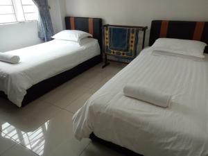 Postel nebo postele na pokoji v ubytování Hotel Mutiara KGMMB, Melaka