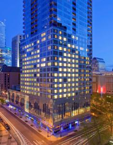 a tall building with lights on in a city at Hyatt at Olive 8 in Seattle