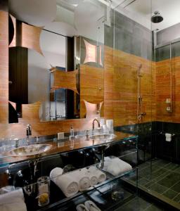 a bathroom with two sinks and a large mirror at Andaz 5th Avenue, By Hyatt in New York