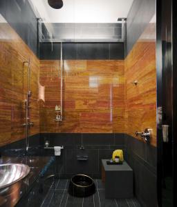 
a bathroom with a sink, toilet, and shower stall at Andaz 5th Avenue-a concept by Hyatt in New York
