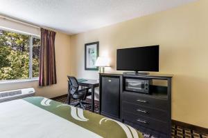 a hotel room with a bed and a flat screen tv at Quality Inn Huntersville near Lake Norman in Huntersville