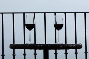 two glasses of red wine sitting on a table at Agunì Agriturismo e Locanda in Palizzi +34 photos