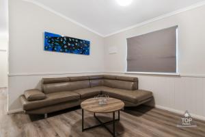 
a living room filled with furniture and a painting on the wall at Jurien Bay Tourist Park in Jurien Bay

