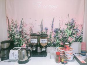 a table with two jars of flowers on it at AIRPORT Guesthouse in Busan