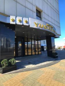a building with a sign on the side of it at Hotel Yubileiny in Minsk