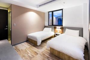 Postel nebo postele na pokoji v ubytování Greatt Hotel