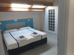 a bedroom with a bed with a blue headboard at Residenza Cuntin in Carloforte