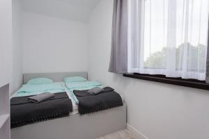 Postel nebo postele na pokoji v ubytování Nowe Apartamenty Puck