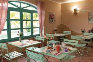 a restaurant with tables and chairs with flowers on them at Villa Primaluce in Pizzo