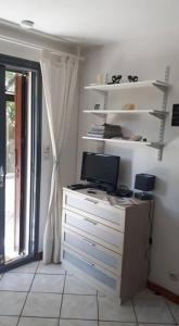 a room with a desk with a computer and a window at Petite maison proche océan Boulevard de l'amelie in Soulac-sur-Mer