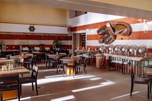 a restaurant with tables and chairs in a room at Crown Regency Beach Resort in Boracay