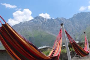 a couple of hammocks with mountains in the background at Rooms 3 in Kazbegi