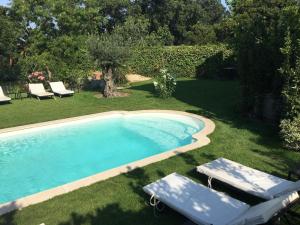 a swimming pool with two lounge chairs next to it at Villa Louise-Rose in Villeneuve-Loubet