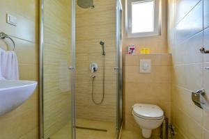 a bathroom with a shower and a toilet and a sink at Apartmani Marina Kopitovic in Petrovac na Moru +73 photos
