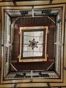 a glass window in a room with a ceiling at Moroccan Dream Hostel in Fès