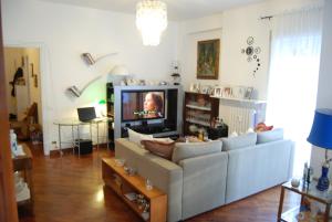 a living room with a couch and a tv at La Badia del Cavaliere in Rome