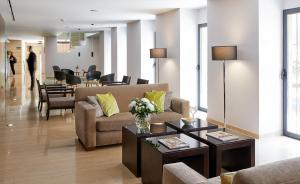 a living room with a couch and a table at Hotel Rey Alfonso X in Seville