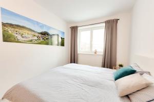 a bedroom with a bed with a painting on the wall at Apartments Julian Explore in Rateče