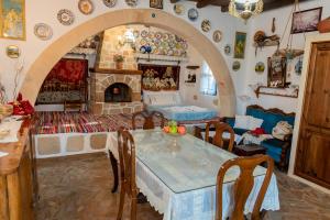 a living room with a table and a fireplace at Archontiko Stegna in Archangelos