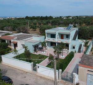 an aerial view of a white house with a yard at Villa Marzia in Porto Cesareo