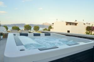 a hot tub on the roof of a house at Ostria Hotel  in Adamantas