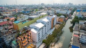 an overhead view of a city with a river and buildings at Nouvo City Hotel in Bangkok