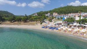 an aerial view of a beach with chairs and umbrellas at Seaside 2 in Agia Paraskevi