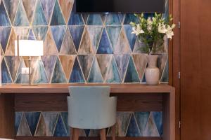 a table with a chair and a vase with flowers at Palazzo Scamozzi in Vicenza