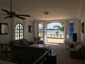 a living room with a view of the ocean at RIAD DES OISEAUX in El Aouamra