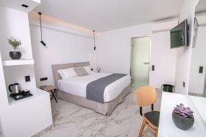 Ein Bett oder Betten in einem Zimmer der Unterkunft Kallos Imar Boutique Hotel