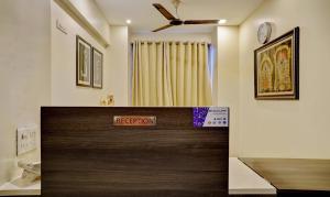 a reception desk in a room with a ceiling at Treebo Trend Bhagyashree Executive Hadapsar in Pune