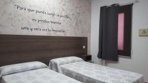 Postel nebo postele na pokoji v ubytování Hostal Almagro