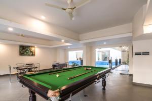 a pool table in a living room with a ceiling at Regenta Central North Goa, Arpora in Arpora