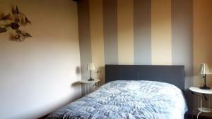 a bedroom with a bed and two tables with lamps at La Cappuccina in Corniglio