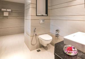 a bathroom with a toilet and a sink at Regenta Central North Goa, Arpora in Arpora +19 photos