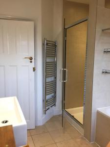a bathroom with a shower and a sink at Marble Apartments Tooting House in London