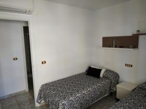 A bed or beds in a room at Apartamento Torrox Costa