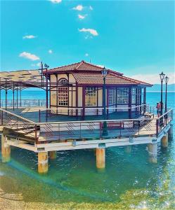 a building on a pier in the water at Evita's Studios in Loutra Edipsou