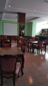 a waiting room with tables and chairs and a whiteboard at West Wing Mansion in Bangkok