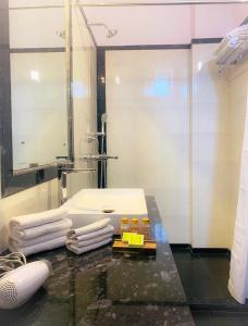 a bathroom with a sink and towels on a counter at Bhola Bhawan Bed and Breakfast in Jaipur +24 photos