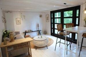a living room with a sink and a table at Sunny Guesthouse in Bergen