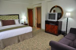 a hotel room with a bed and a tv at The Murray Hotel in Silver City