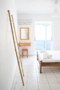 a room with a ladder and a bed at Afroditi Pansion in Agios Nikitas