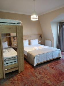 a bedroom with two beds and a bunk bed at Boutique Hotel BelleVue in Sighnaghi