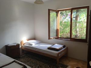 a small room with two beds and a window at Adriatic Leisure Apartment in Novi Vinodolski