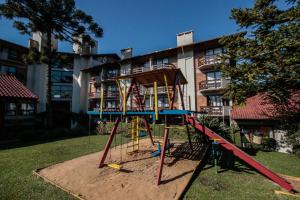 an empty playground in front of a building at Residencial Pousada Serrano in Gramado +3 photos
