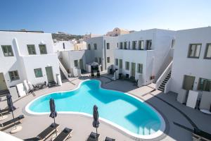 a view of the pool in the courtyard of a hotel at Kallos Imar Boutique Hotel in Mesaria