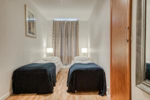 Postel nebo postele na pokoji v ubytování Trondheim Leilighetshotel