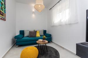 a living room with a blue couch and a table at Apartments Marija in Baška